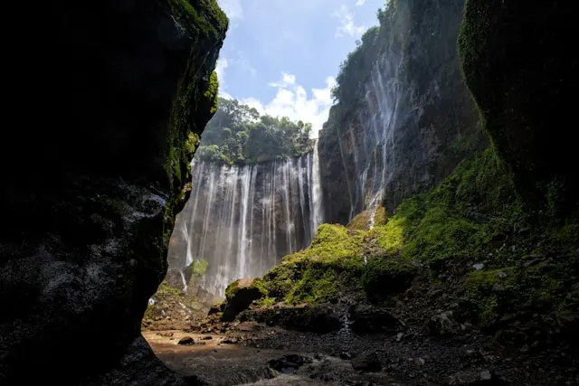 Tumpak Sewu waterfall in East Java surrounded by tropical rainforest